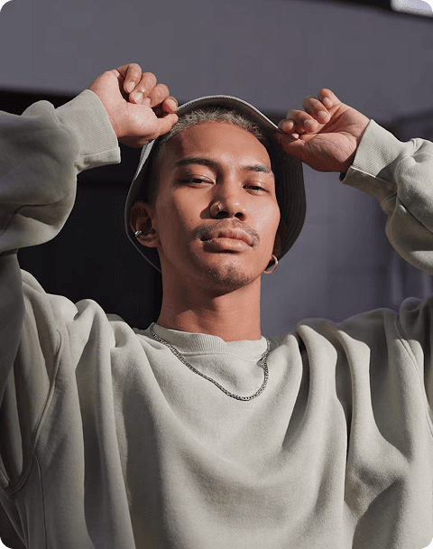A young man posing with his hand on his head